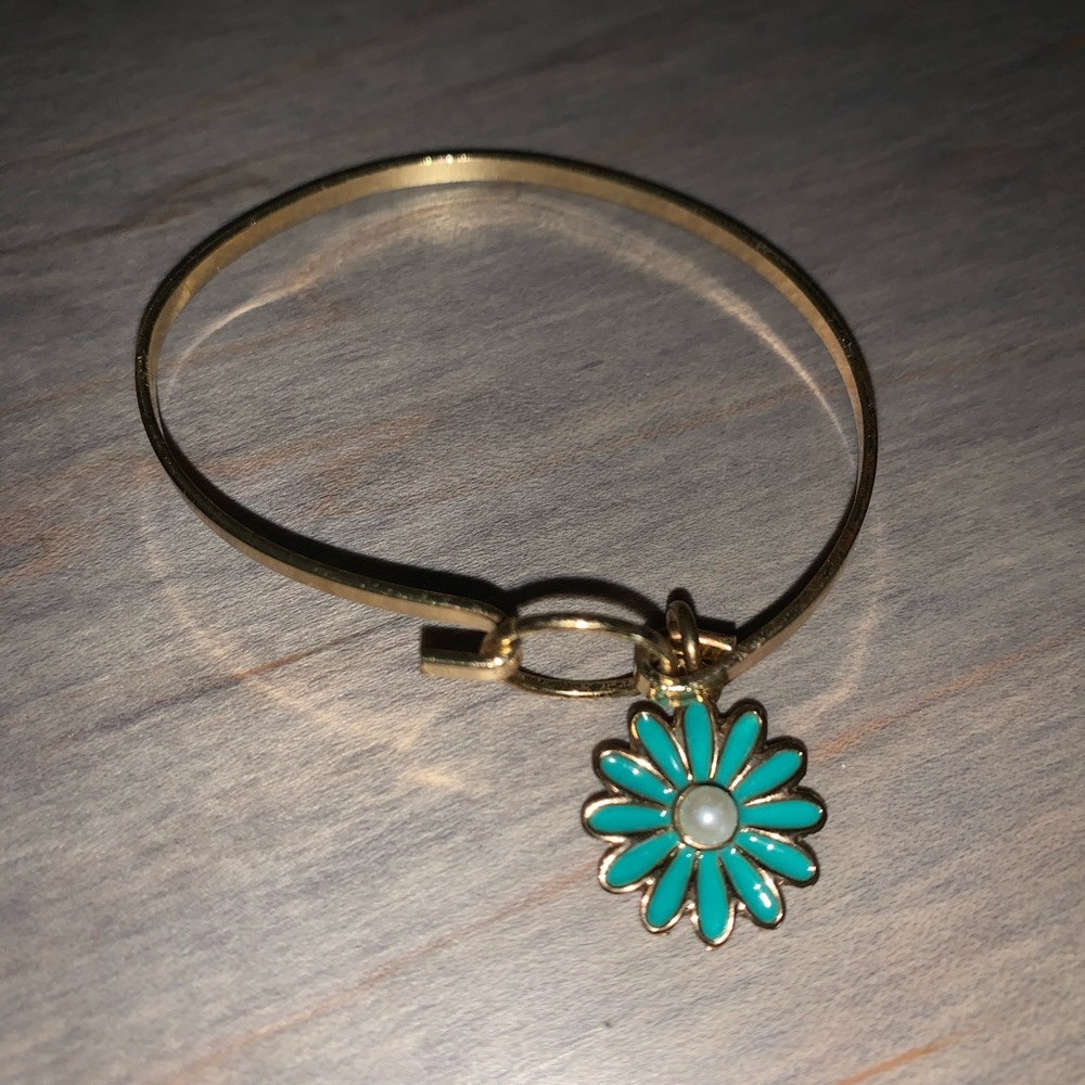 Gold bracelet w/ blue sunflower.